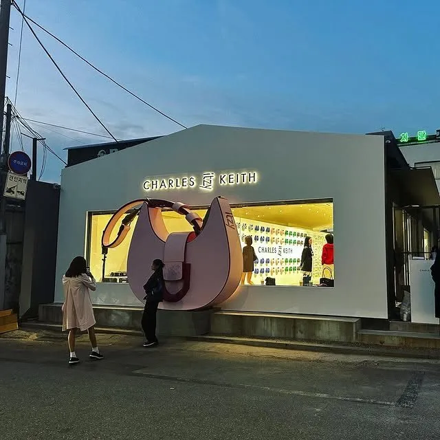 Exterior of a lit CHARLES & KEITH pop-up store
